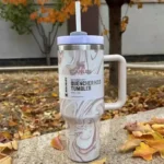 Stanley-Swirl-Quencher-H2.0-40-oz-Experience-Ice-Cold-Bliss-Ergonomic-Stanley-Tumbler-Thermos-rose-quarts-bg-flower