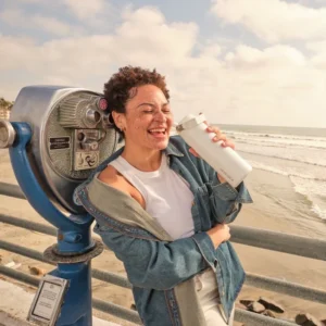 Stanley-IceFlow-Bottle-16oz-with-Flip-Straw-Leakproof,-Cold-Insulated-Stainless-Steel-Water-Bottle-Frost-girl-holding